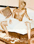 Dhani shirtless on bed